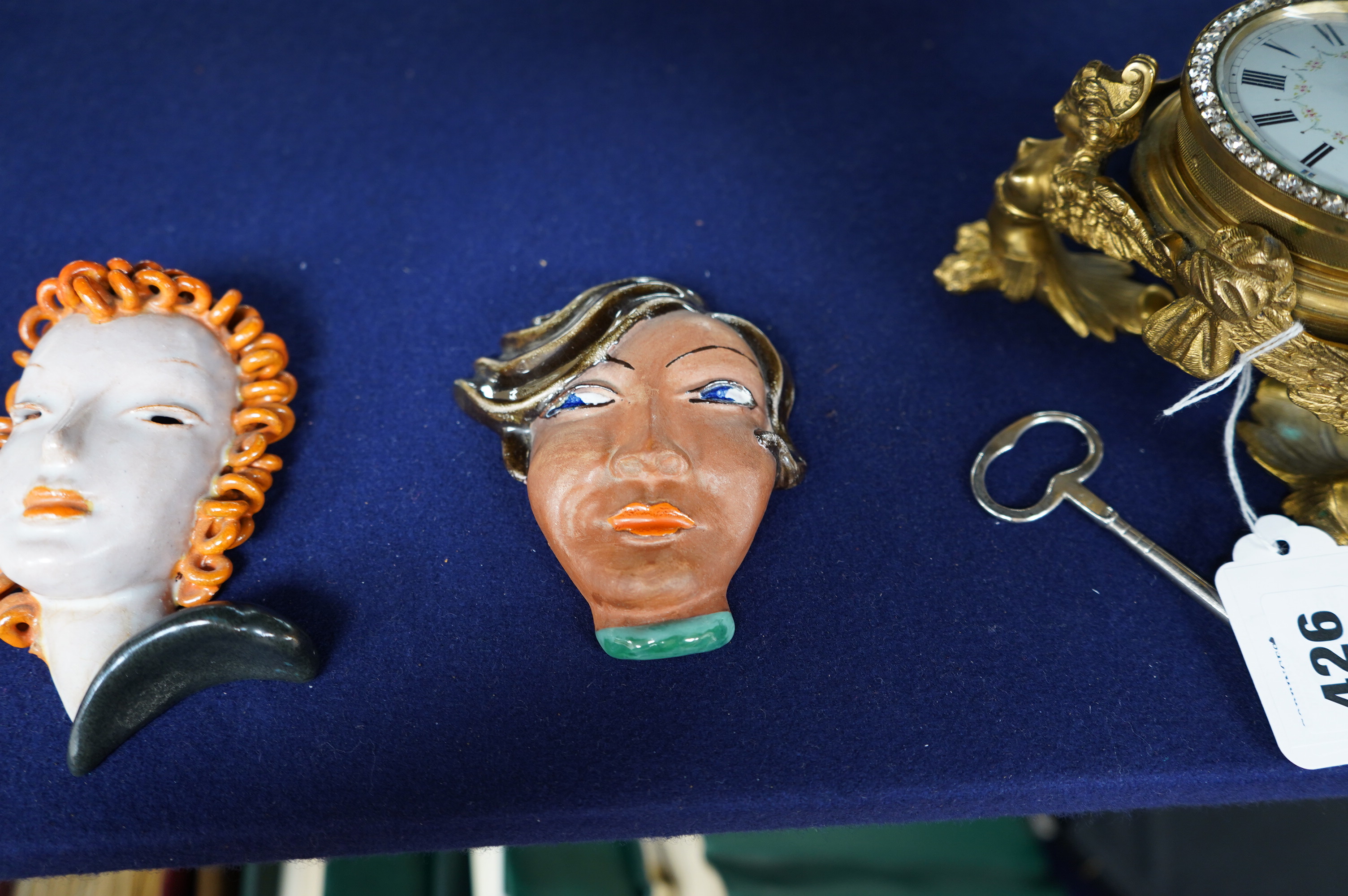 A Goldscheider wall mask, 12.5cm and two other Art Deco masks. Condition - Goldscheider mask good, other two fair